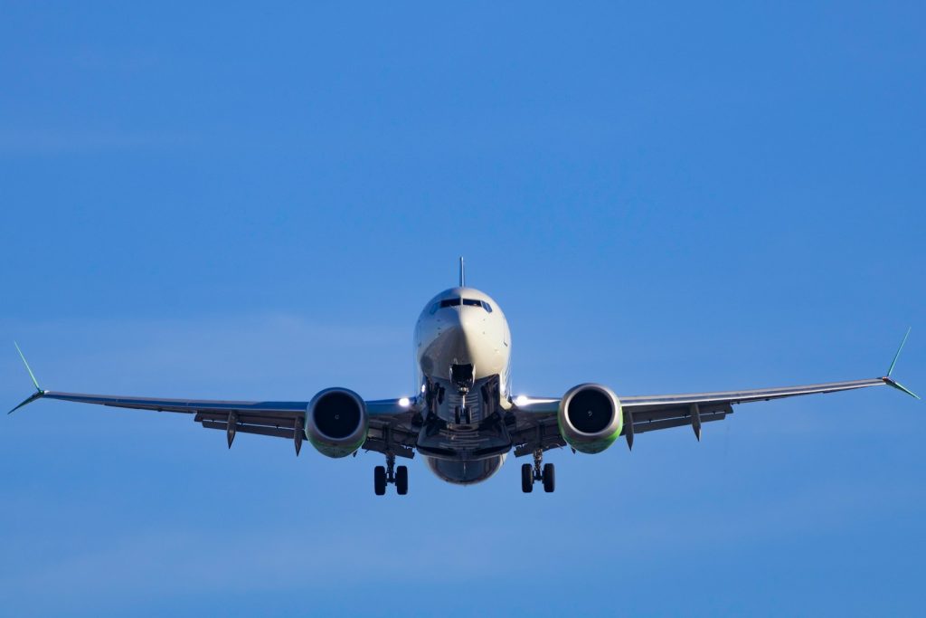 A large jetliner flying through a blue sky